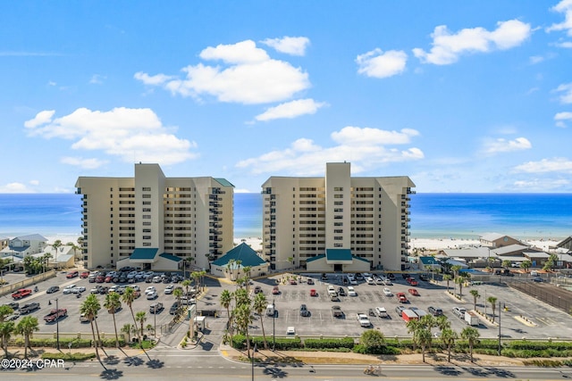 drone / aerial view with a water view and a beach view