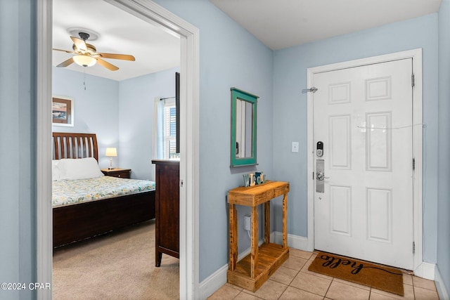 tiled foyer with ceiling fan