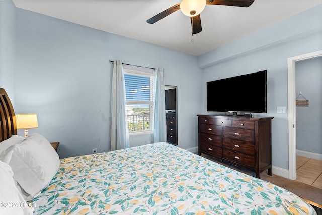 bedroom with ceiling fan and light tile patterned floors