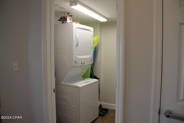 laundry area featuring stacked washer / dryer