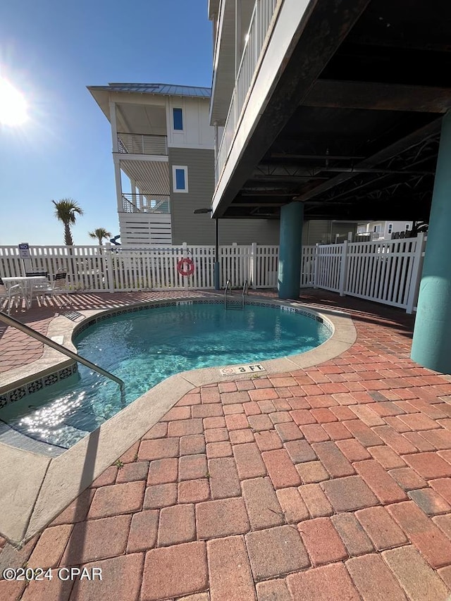 view of swimming pool with a patio area