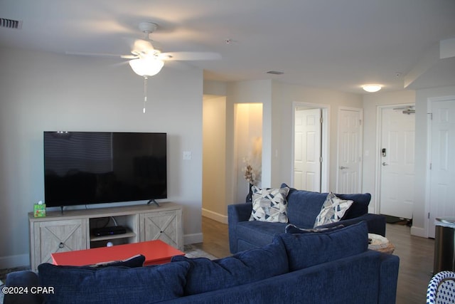 living room featuring hardwood / wood-style floors and ceiling fan