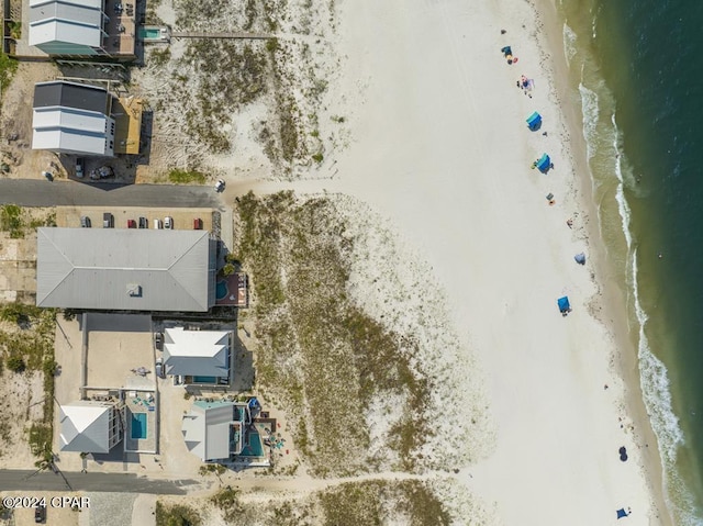 birds eye view of property with a water view and a view of the beach