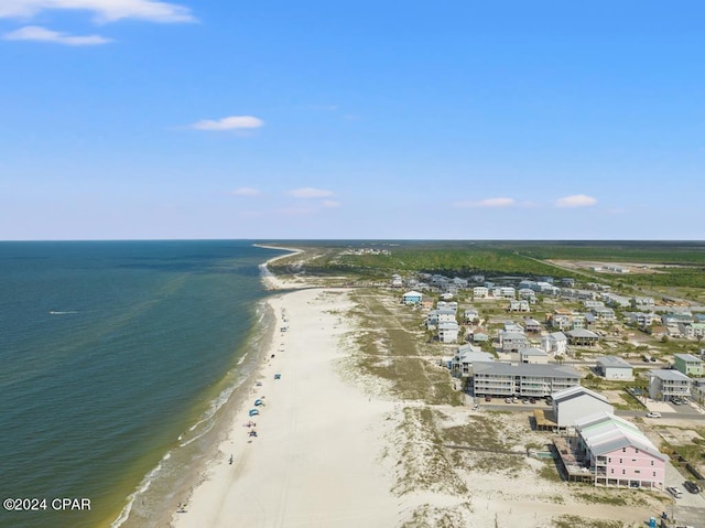 drone / aerial view with a water view and a beach view