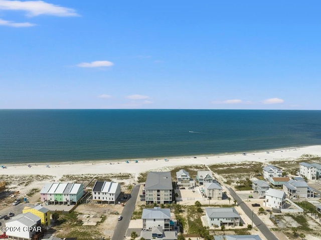 birds eye view of property featuring a water view and a beach view