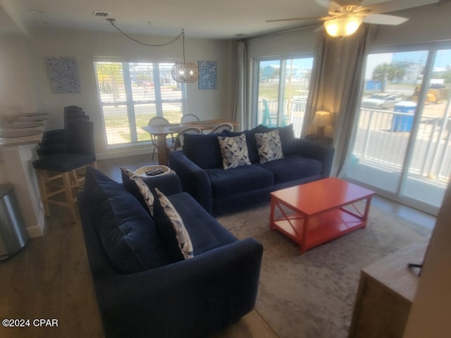 living room featuring ceiling fan, a healthy amount of sunlight, and wood-type flooring