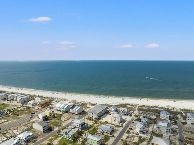 bird's eye view featuring a water view and a beach view