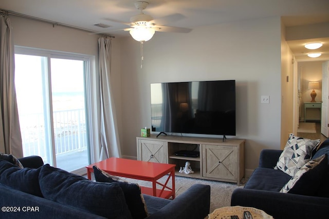 living room with ceiling fan and carpet floors