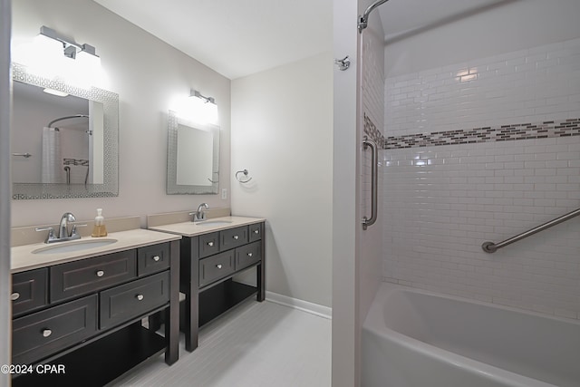 bathroom with tub / shower combination, vanity, and baseboards