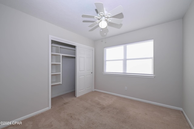 unfurnished bedroom featuring carpet floors, a closet, and baseboards