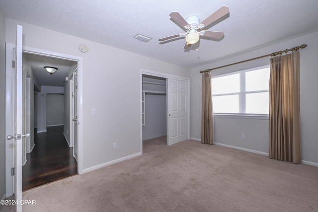 unfurnished bedroom featuring a closet, carpet flooring, visible vents, and baseboards