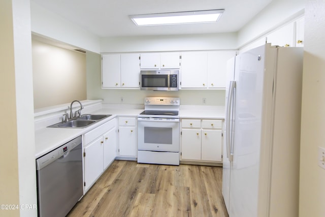 kitchen with sink, light wood-type flooring, white cabinetry, and stainless steel appliances