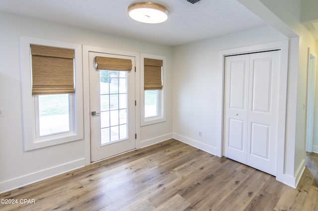 doorway to outside with light wood-type flooring