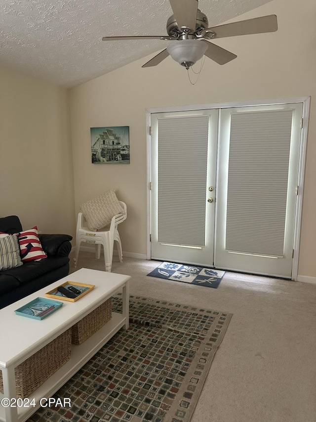 entryway with carpet, ceiling fan, a textured ceiling, and french doors