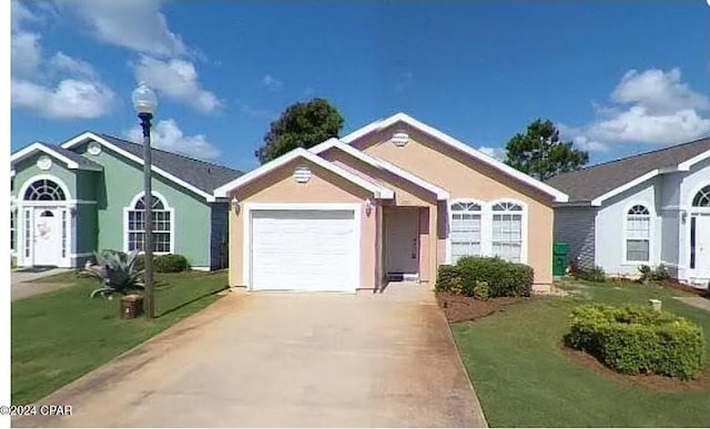 ranch-style house featuring a garage and a front yard