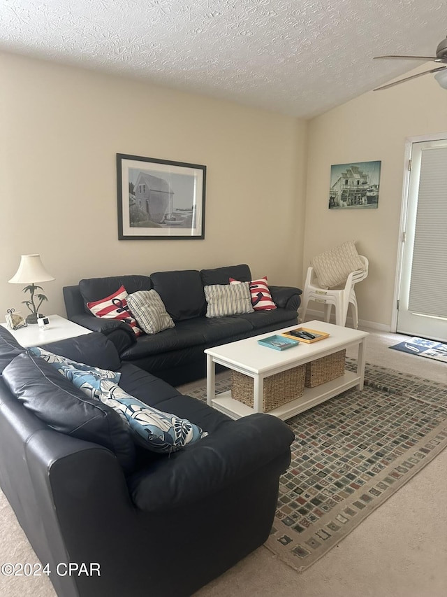 carpeted living room with a textured ceiling and ceiling fan