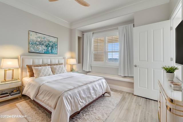 bedroom featuring crown molding, light hardwood / wood-style flooring, and ceiling fan