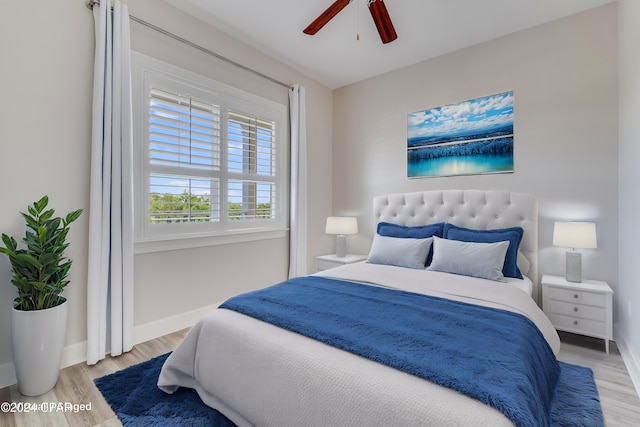 bedroom with light hardwood / wood-style flooring and ceiling fan