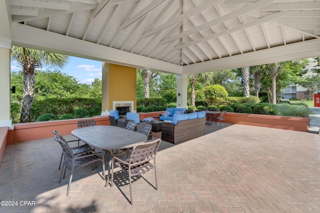 3001 W 10th St Unit 405, Panama City, FL 32401 - view of patio / terrace featuring outdoor dining space, an outdoor living space with a fireplace, and a gazebo