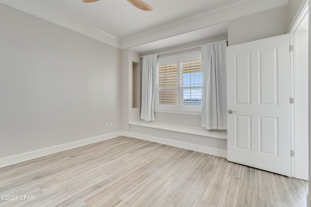3001 W 10th St Unit 405, Panama City, FL 32401 - spare room with crown molding, light wood-style floors, a ceiling fan, and baseboards