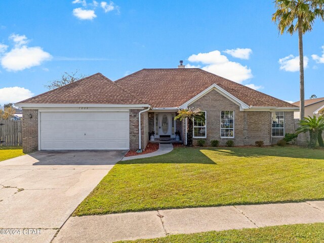 single story home with a front yard and a garage