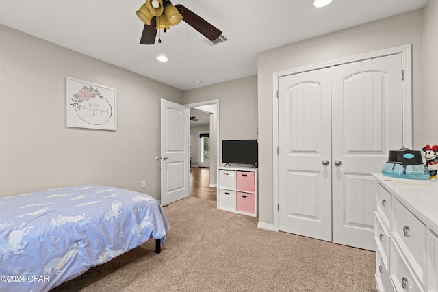 carpeted bedroom with a closet and ceiling fan