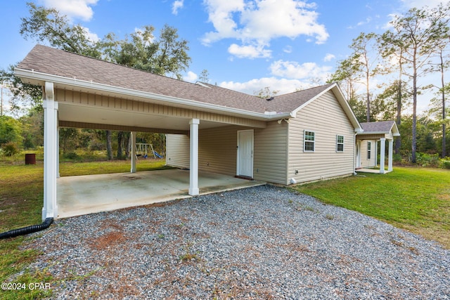 exterior space featuring a yard and a carport