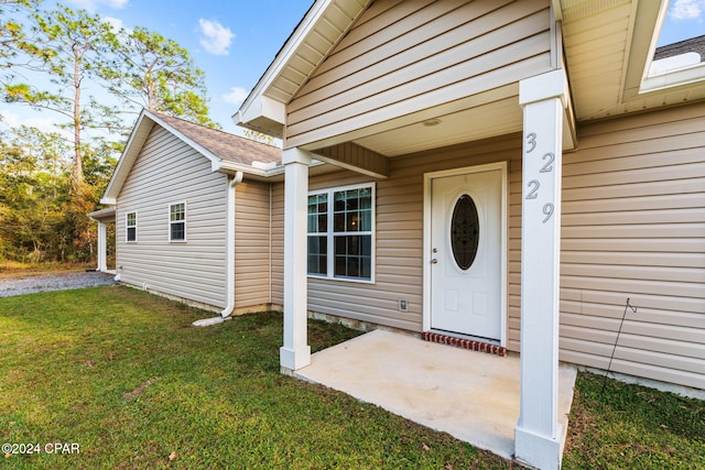 doorway to property featuring a yard