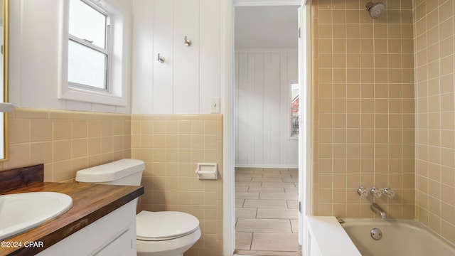 full bathroom with tile patterned floors, vanity, toilet, and tiled shower / bath combo