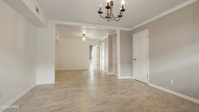 spare room featuring a chandelier and ornamental molding