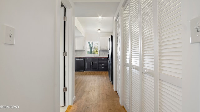 hall with sink and light hardwood / wood-style flooring