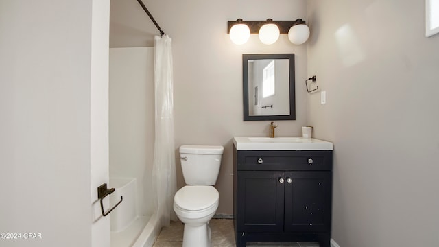 bathroom featuring tile patterned floors, vanity, toilet, and walk in shower