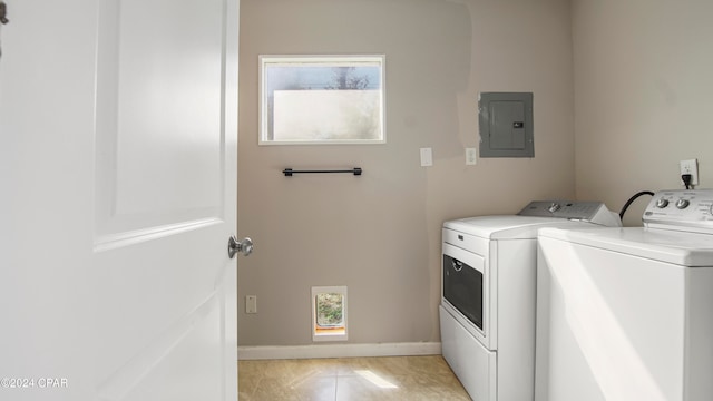 laundry area featuring washer and dryer, light tile patterned flooring, and electric panel