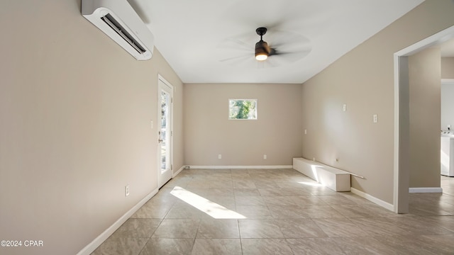 empty room featuring a wall unit AC and ceiling fan