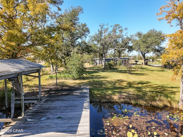 dock area featuring a yard and a water view