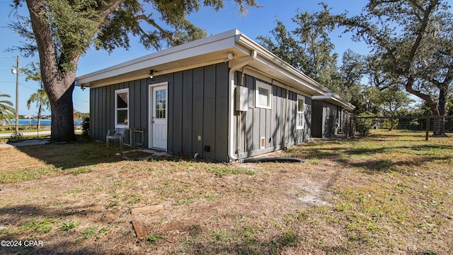 view of side of home with a yard