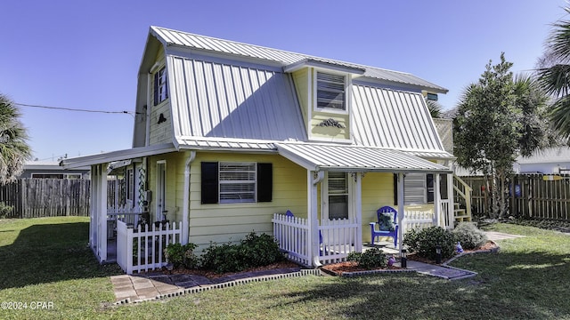 202 3rd St, Mexico Beach, FL 32456 - view of front of home featuring a porch and metal roof
