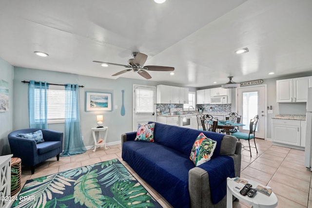 living room with ceiling fan and light tile patterned floors