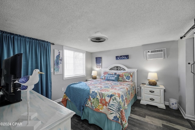 202 3rd St, Mexico Beach, FL 32456 - bedroom featuring wood finished floors, a barn door, a wall mounted air conditioner, a textured ceiling, and baseboards
