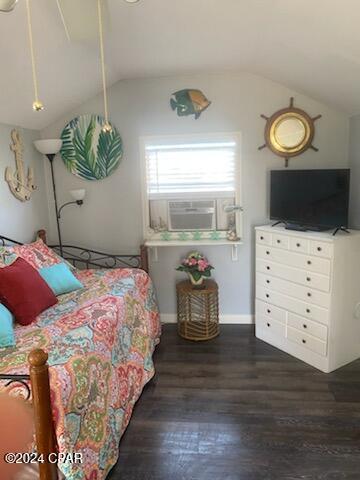 bedroom with vaulted ceiling, cooling unit, and dark hardwood / wood-style flooring