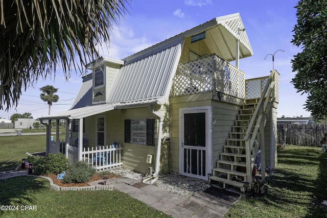 202 3rd St, Mexico Beach, FL 32456 - view of front of home with metal roof and stairway