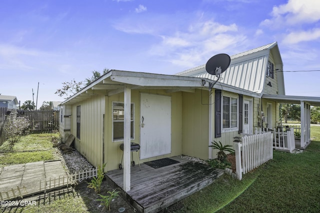 202 3rd St, Mexico Beach, FL 32456 - view of side of home with a gambrel roof and metal roof