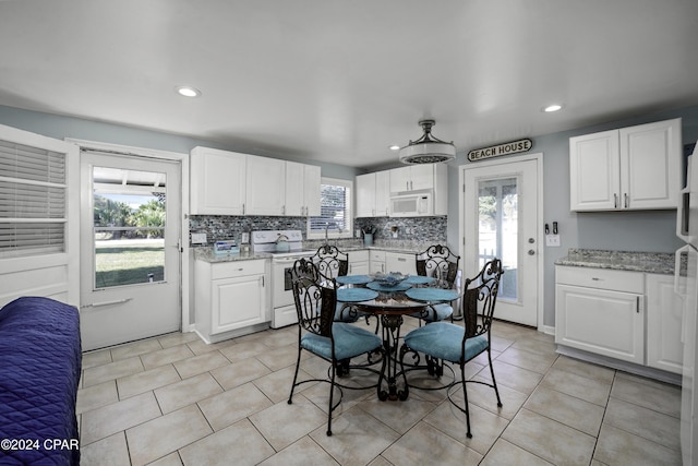 202 3rd St, Mexico Beach, FL 32456 - kitchen featuring white appliances, healthy amount of natural light, white cabinetry, and recessed lighting