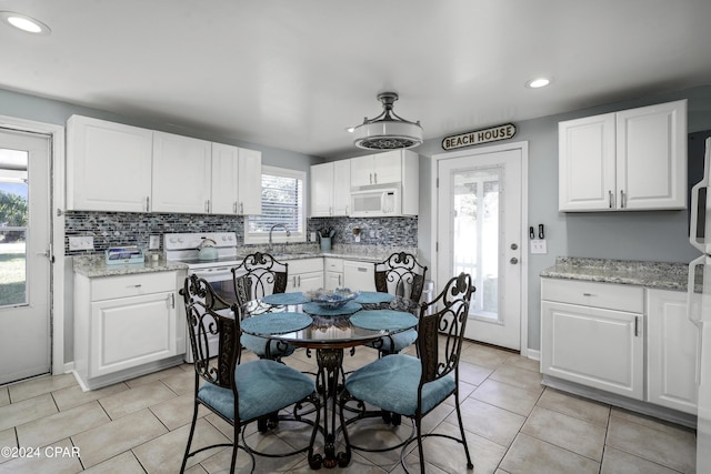 202 3rd St, Mexico Beach, FL 32456 - dining area featuring light tile patterned floors, recessed lighting, and baseboards