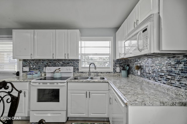 202 3rd St, Mexico Beach, FL 32456 - kitchen featuring white appliances, a sink, white cabinetry, and decorative backsplash