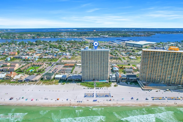 drone / aerial view with a water view and a beach view