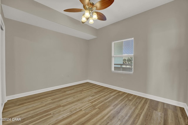 spare room featuring light hardwood / wood-style floors and ceiling fan