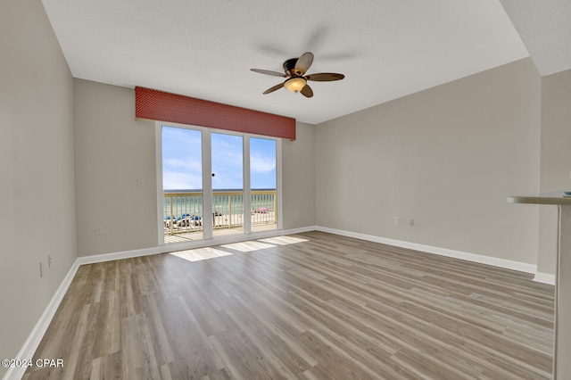 unfurnished living room featuring light hardwood / wood-style flooring, a textured ceiling, and ceiling fan