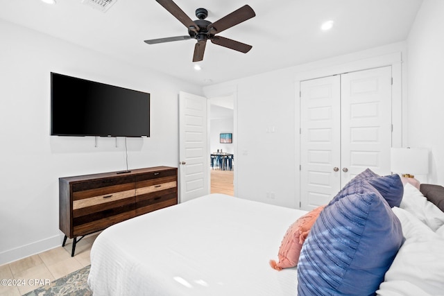 bedroom with ceiling fan and a closet