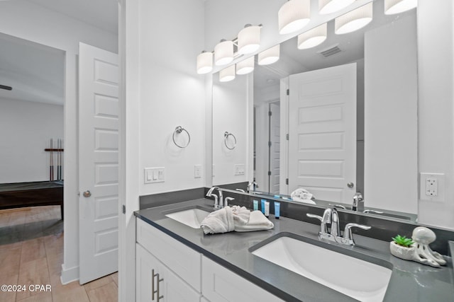 bathroom with hardwood / wood-style floors and vanity